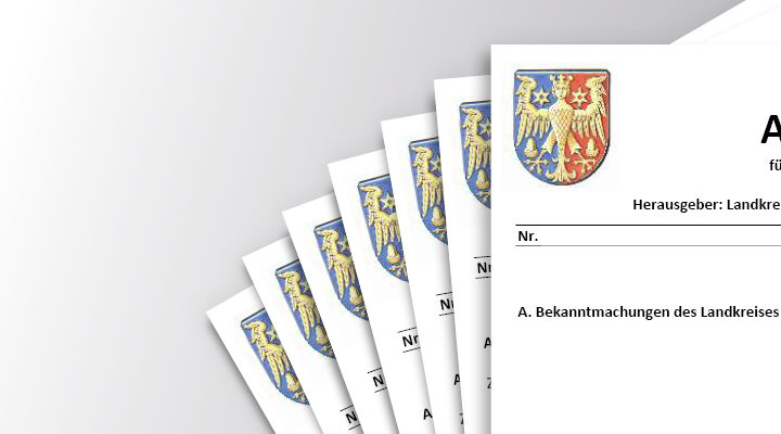 Wappen des Landkreises Aurich und ein Stapel von Amtsblättern